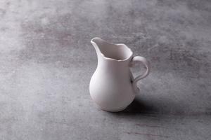 theepot creamer, kop en schotel op cement board foto