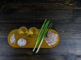 twee glazen koude wodka op een houten plank foto