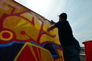 Charkov, Oekraïne - mei 27, 2017 festival van straat kunsten. jong jongens trek graffiti Aan portable houten muren in de centrum van de stad. de werkwijze van schilderij Aan muren met aërosol verstuiven blikjes foto