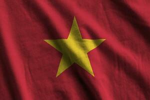 Vietnam vlag met groot vouwen golvend dichtbij omhoog onder de studio licht binnenshuis. de officieel symbolen en kleuren in banier foto