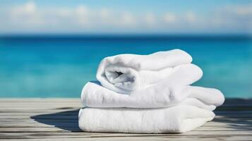 wit strand handdoeken Aan hout over- wazig blauw zee achtergrond, generatief ai foto