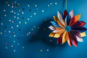 een kleurrijk papier bloem hangende Aan een blauw muur. ai-gegenereerd foto