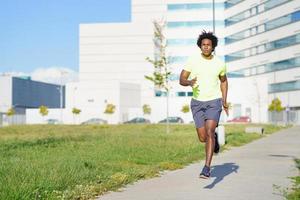 zwarte atletische man loopt in een stadspark. foto