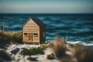 een miniatuur houten huis zit Aan de strand in de buurt de oceaan. ai-gegenereerd foto