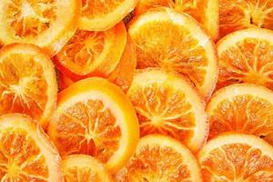 schijfjes gedroogde sinaasappels of mandarijnen op een blauwe achtergrond foto