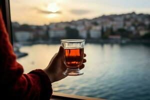 een vrouw slokjes Turks thee met de Bosporus baai net zo haar backdrop ai gegenereerd foto