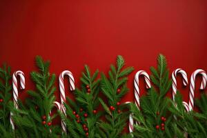 Kerstmis achtergrond met snoep wandelstokken en Spar takken Aan rood achtergrond. ai gegenereerd. foto