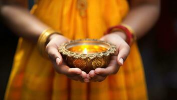 dichtbij omhoog van vrouw handen Holding diwali olie lamp. ai gegenereerd. foto