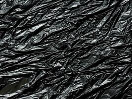 zwart plastic zak achtergrond. textuur. zwart plastic achtergrond. foto