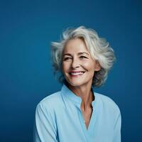 55 jaar oud glimlachen vrouw met grijs haar- Aan een blauw achtergrond. ai generatief foto