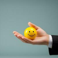 arbeiders hand- Holding een geel glimlachen emoji bal, ai generatief foto