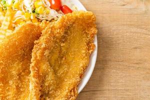 fish and chips met minisalade op wit bord foto
