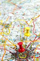 een rood Duwen pin is Aan een kaart van een stad foto