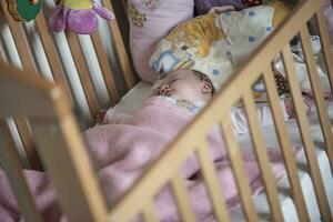 pasgeboren baby slapen Bij huis in bed foto