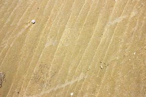 zand textuur achtergrond op het strand foto