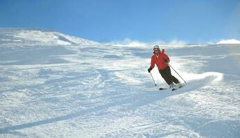 skiën op verse sneeuw in het winterseizoen op een mooie zonnige dag foto