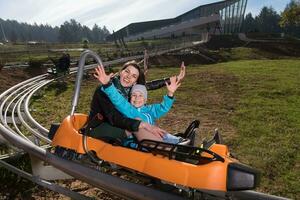 moeder en zoon geniet het rijden Aan alpine kustvaarder foto