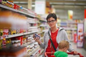 moeder met baby in boodschappen doen foto