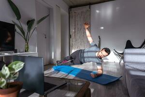 Latijns Mens Bij huis voor pushup of plank opleiding online. foto