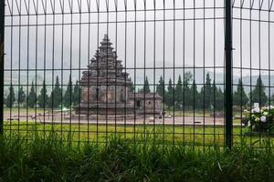 arjuna en semar tempels achter een zwart metalen hek foto