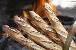 mand met brood gebakken in een houtoven foto