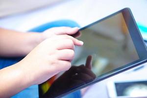 kind gebruikt tabletcomputer om onderwijs te leren foto
