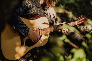 musicus Mens spelen gitaar Bij zonsondergang detailopname foto