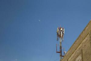 cellulair antenne. communicatie Aan een gebouw dak top foto