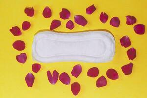 vrouwelijk hygiëne producten Aan geel achtergrond. concept van kritiek dagen, menstruatie- fiets, periode dagen, pms foto