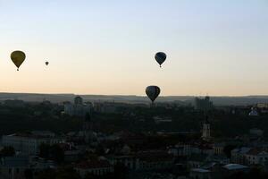 heet lucht ballonnen vliegend over- een stad foto