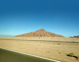 vulkaan in de woestijn en een weg foto