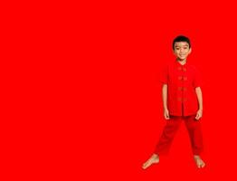 weinig jongen mode glimlachen kind in rood Chinese jurk, stijl en mode ideeën voor kinderen. Chinese nieuw jaar foto