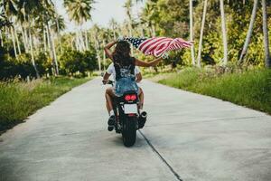 jong paar in liefde, rijden een motorfiets, knuffel, passie, vrij geest, Amerikaans vlag foto