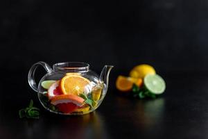 hete fruitthee met citroen, munt, sinaasappel, limoen en grapefruit foto