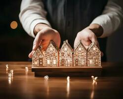 man's hand- subtiel Holding klein houten huizen. ai gegenereerd foto