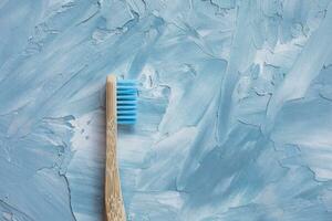 een blauw bamboe tandenborstel. plastic vrij, nul verspilling concept. top visie, wit en blauw achtergrond, kopiëren ruimte foto