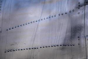 vliegtuigen huid close-up. klinknagels op grijs metaal foto