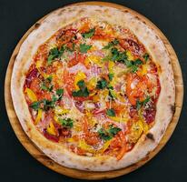 verse heerlijke pizza gemaakt in een haardoven met worst, peper en tomaten foto