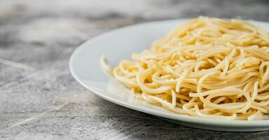 gekookt spaghetti Aan een bord. foto