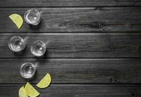 wodka in een schot glas en citroen plakjes. foto