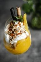 biologische mango en passievrucht tropische ijscoupe in wijnglas foto