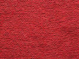structuur van rood gebreid kleding stof foto