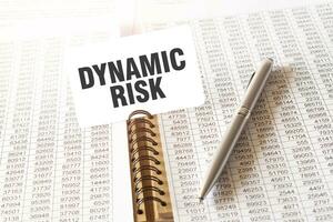 tekst dynamisch risico Aan papier kaart, pen, financieel documentatie Aan tafel foto