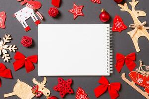 Kerstmis zwart achtergrond met vakantie speelgoed en decoraties. top visie van notebook. gelukkig nieuw jaar concept foto