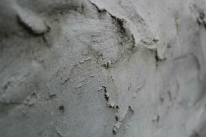 ongelijk cement en zand muur structuur achtergrond, grungy cement muur oppervlak, rustiek zand muur foto