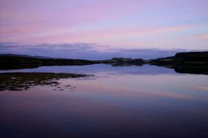 zonsopkomst over- fjord dunvegan met een pastel lucht foto