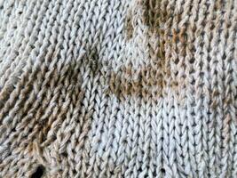 structuur van een gebreid kleding stof, een achtergrond van een wit wol met een patroon van wol foto