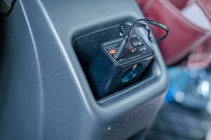 macht bank met opladen kabel aangesloten in op te slaan in de terug stoel zak- van uw auto. foto