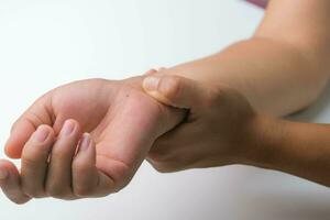 vrouw met pols pijn, doof gevoel of carpaal tunnel syndroom, artritis, neurologisch ziekte. detailopname van vrouw hand- Holding een pijnlijk gewricht. foto