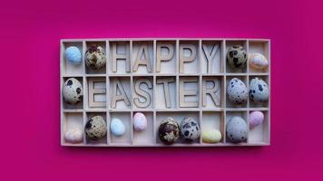 Paas eieren. vrolijke pasen tekst. vakantie decoratie roze achtergrond foto